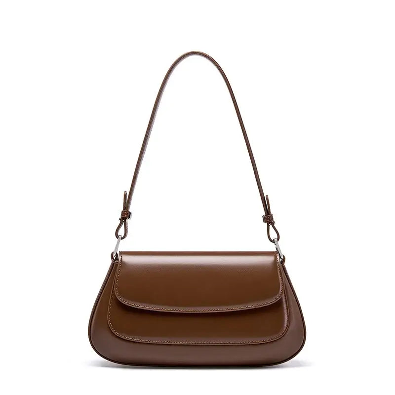 Shoulder bag leather solid brown. Premium cowhide saddle bag with minimalist design and spacious interior.