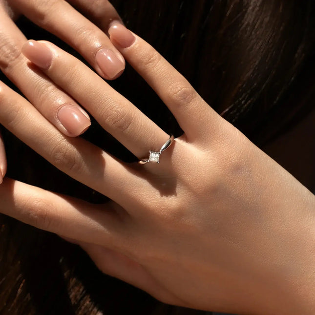 Square Moissanite Ring in 925 Sterling Silver worn on a hand with elegant nails.
