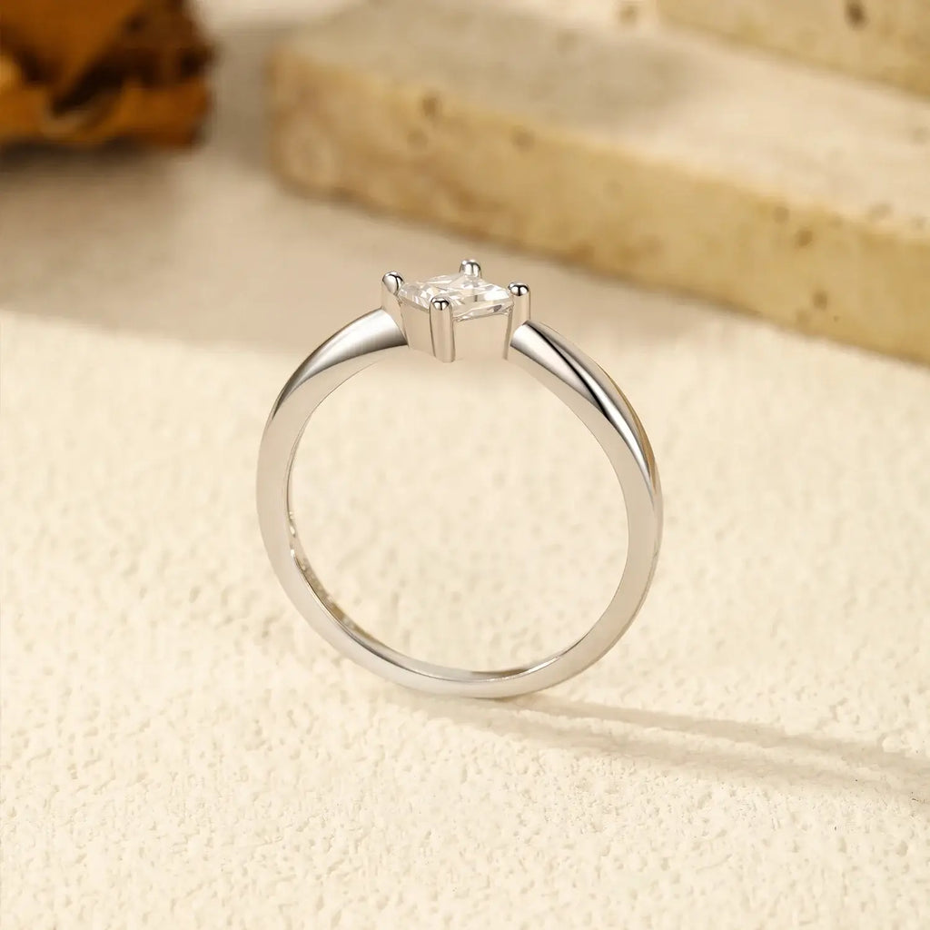 Square Moissanite Ring in 925 Sterling Silver displayed elegantly on a textured surface.