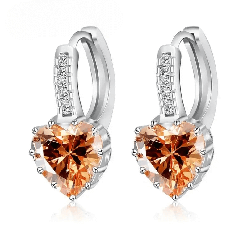 Sterling silver hoop earrings with heart-shaped orange crystal, elegant and trendy design for women.