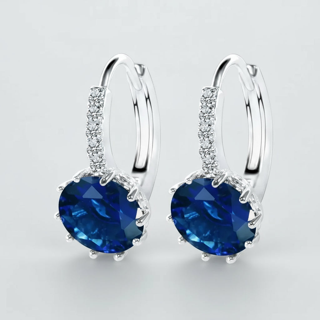 Sterling silver drop hoop earrings with blue cubic zirconia, trendy design for women, perfect for weddings and parties.