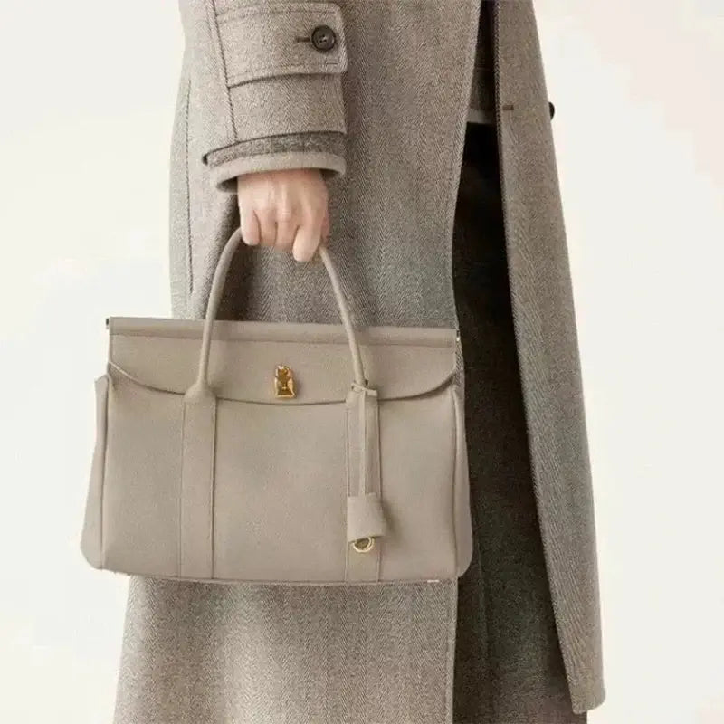 Taupe leather women’s tote bag with matching pouch, stylish and practical for daily use.