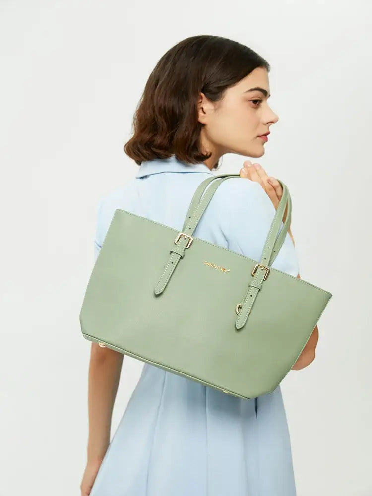 Tote Bag with adjustable shoulder straps in light green color, model holding the bag, stylish and versatile design.