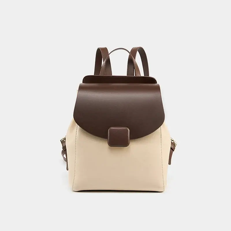 Leather backpack in brown and beige, featuring elegant design and spacious compartments for daily essentials.