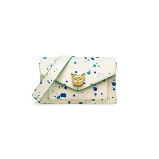 White women’s crossbody bag with paint splatter design and gold fox emblem, ideal for casual elegance.