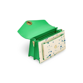 White women’s crossbody bag with paint splatter design and gold fox emblem, featuring a vibrant green interior.