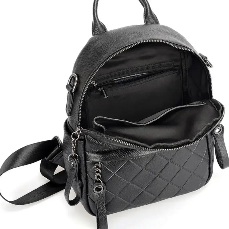Black leather backpack interior showcasing quilted design and zippered pockets for optimal organization.