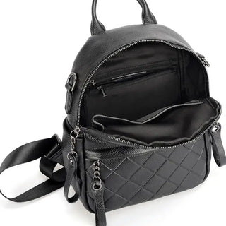Black leather backpack interior showcasing quilted design and zippered pockets for optimal organization.
