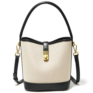 Beige and black women’s casual bucket bag with top handle and crossbody strap featuring gold lock detail.