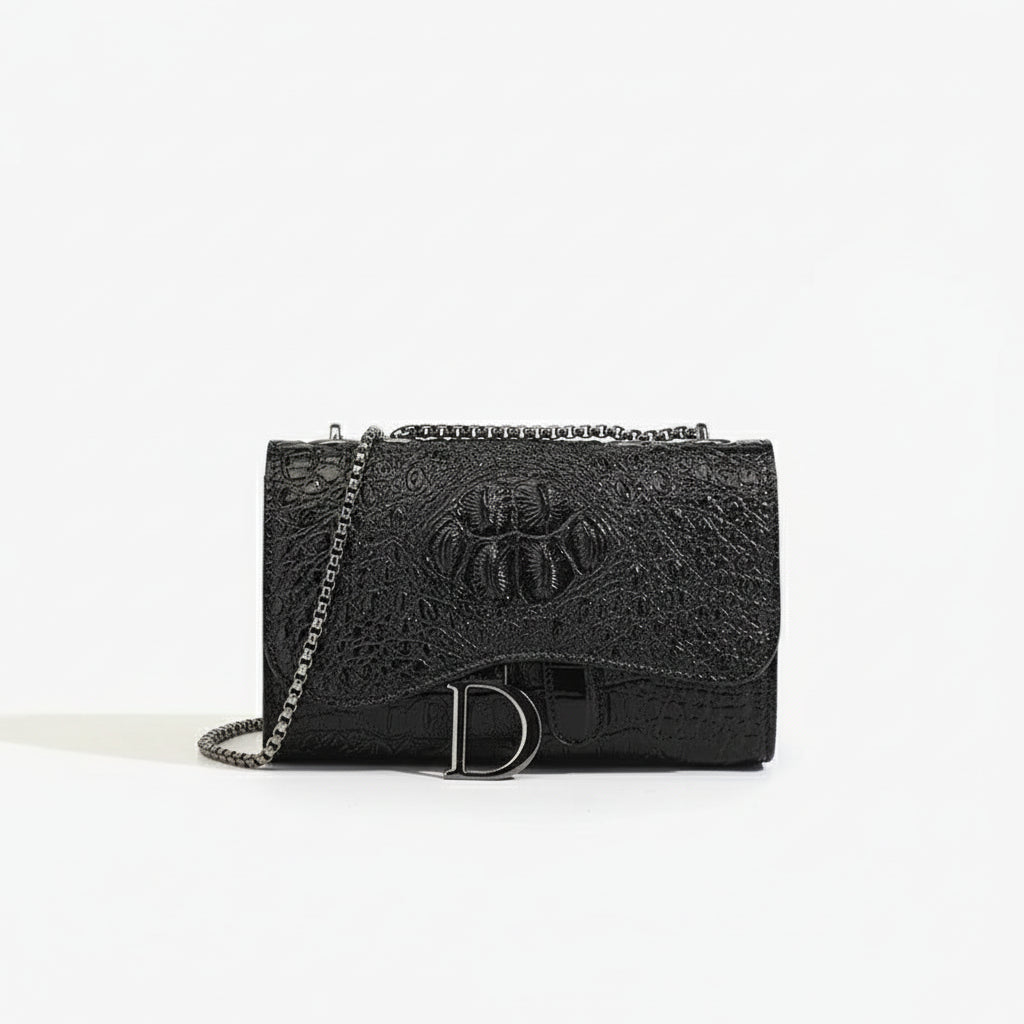 Black crossbody bag with chain, featuring stylish croc embossed design and flap closure, perfect for chic looks.