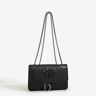Crossbody bag in black faux leather with chain detail, featuring a chic flap design and spacious interior.