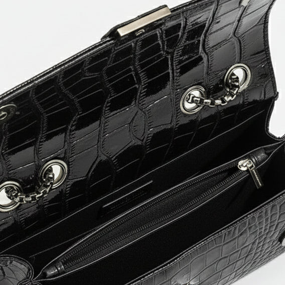 Black crossbody bag interior with chain detail and zip pocket, crafted from high-quality PU leather.
