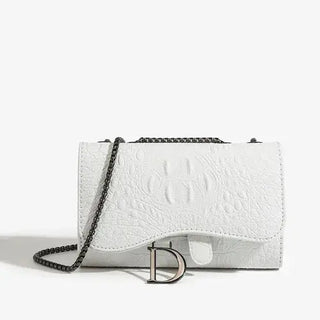 White crossbody bag in textured PU leather with chain strap and chic clasp, perfect for stylish outings.