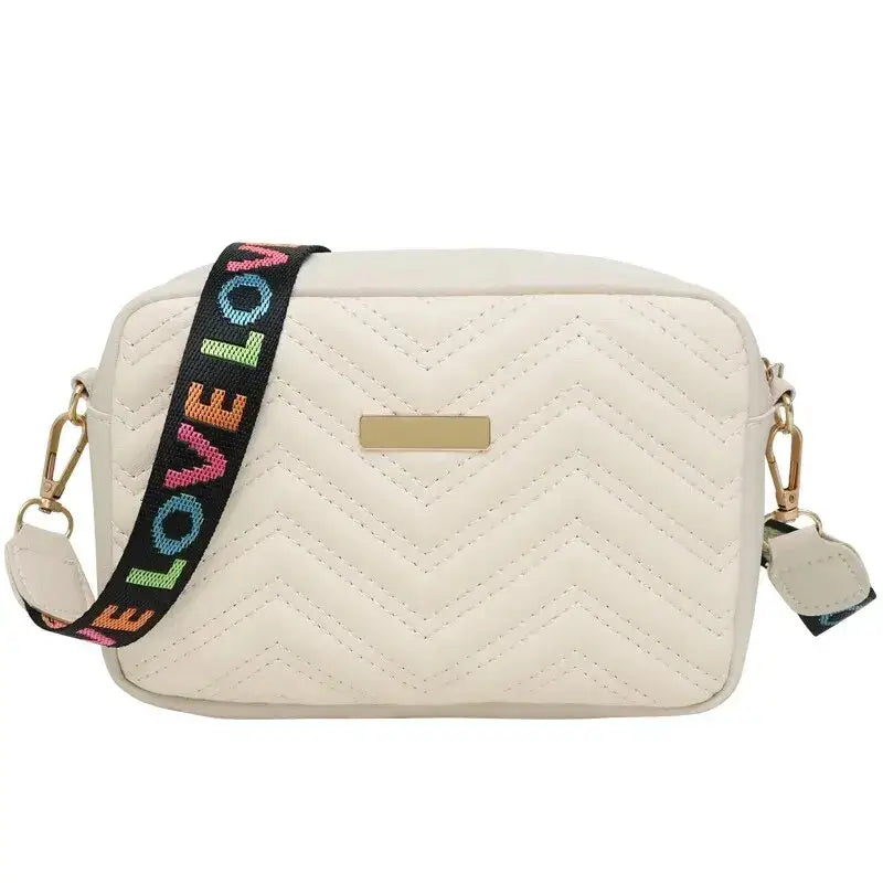Beige quilted women’s crossbody bag with colorful strap for stylish daily wear