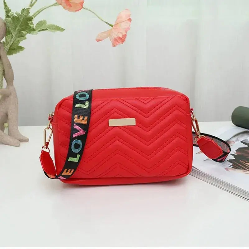 Red Quilted Women’s Crossbody Bag with Colorful Strap, stylish accessory for everyday use.