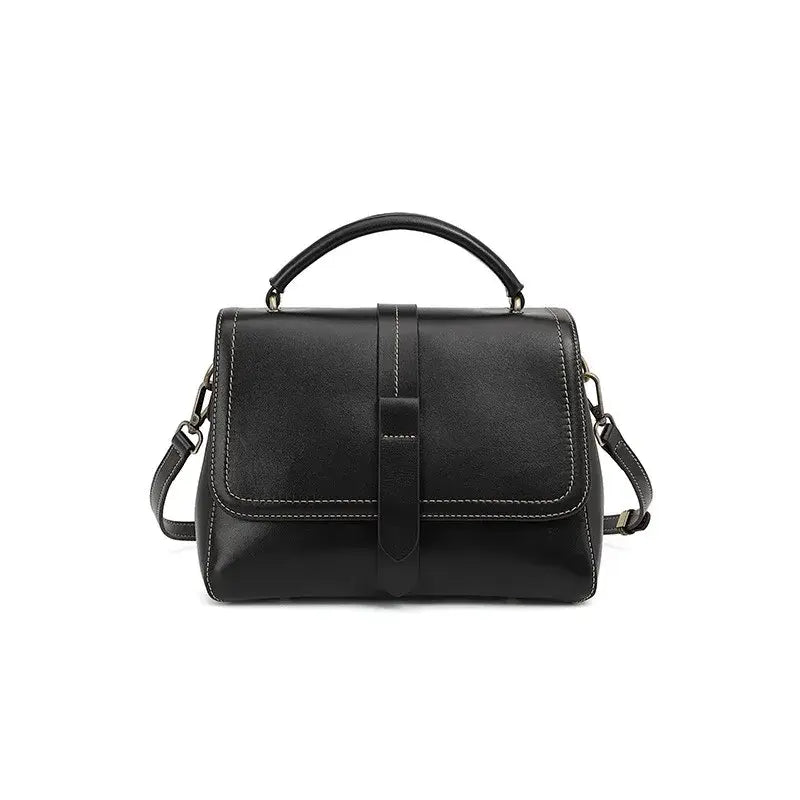 Black crossbody bag, elegant genuine leather flap bag for women with dual straps and rivet accents.