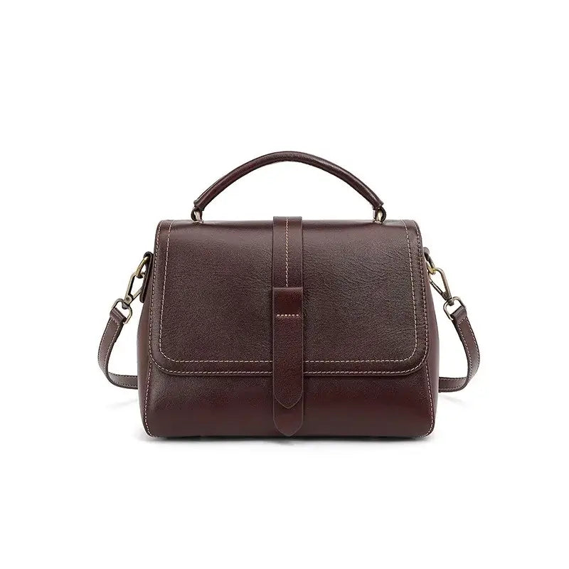 Elegant crossbody bag in dark brown genuine leather with dual straps and chic metallic accents.