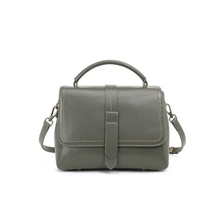 Elegant grey crossbody bag made from genuine leather with dual straps and chic rivet accents.