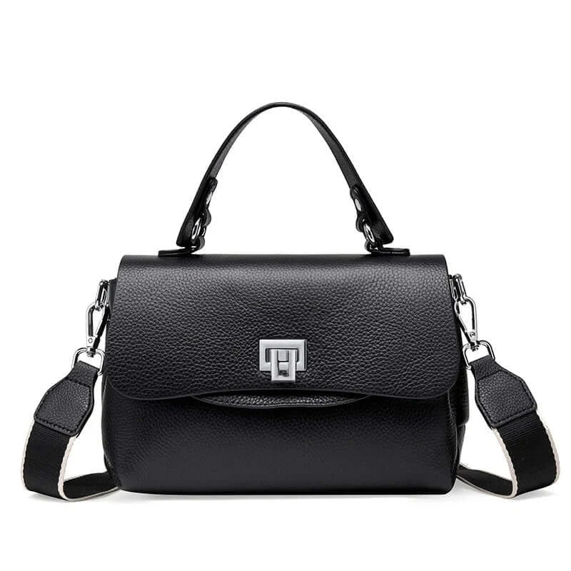 Black crossbody bag with structured design, silver lock detail, and adjustable strap for stylish functionality.