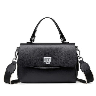 Black crossbody bag with structured design, silver lock detail, and adjustable strap for stylish functionality.
