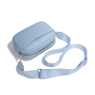 Crossbody bag with wide adjustable strap in light blue PU leather, perfect for everyday use and modern style.