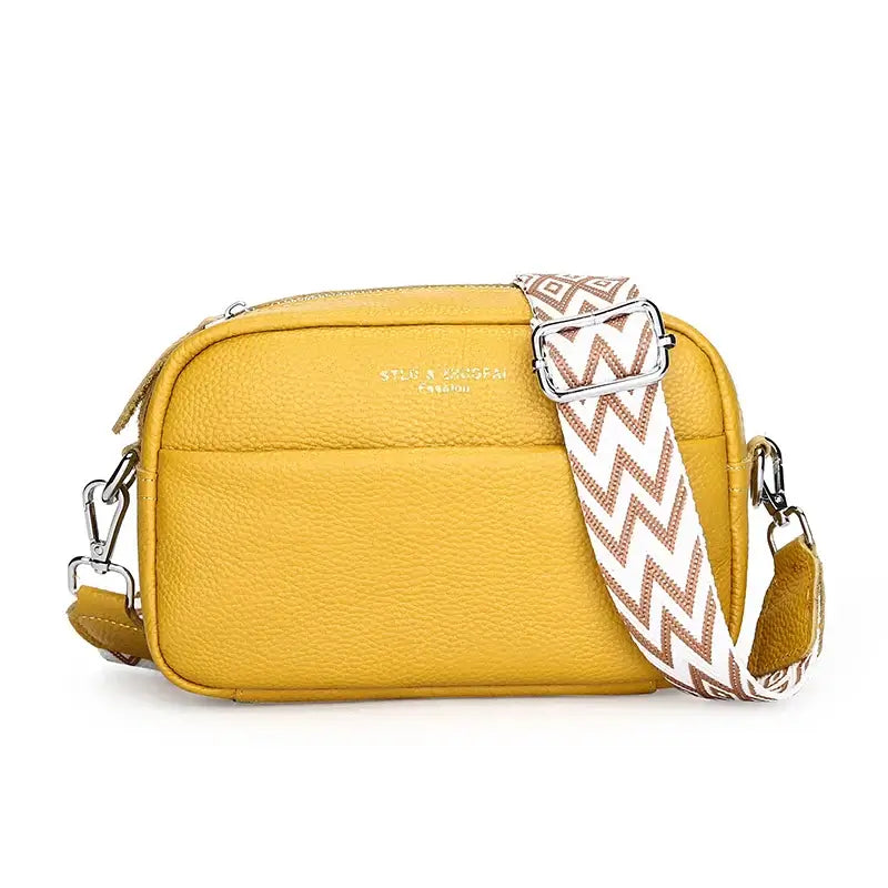 Yellow crossbody bag with adjustable strap and secure zipper closure, perfect for stylish women on the go.