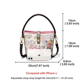 Trendy women's graffiti print bucket bag in pink with top handle and crossbody strap, featuring unique design and practical dimensions.