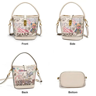 Trendy white women's graffiti print bucket bag with top handle and crossbody strap featuring cartoon design.