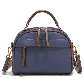 Structured blue leather shoulder bag with brown accents and dual handles, perfect for everyday style and versatility.
