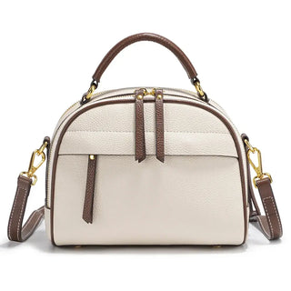 Chic cream leather shoulder bag with brown accents and gold hardware, featuring a structured design and multiple compartments.