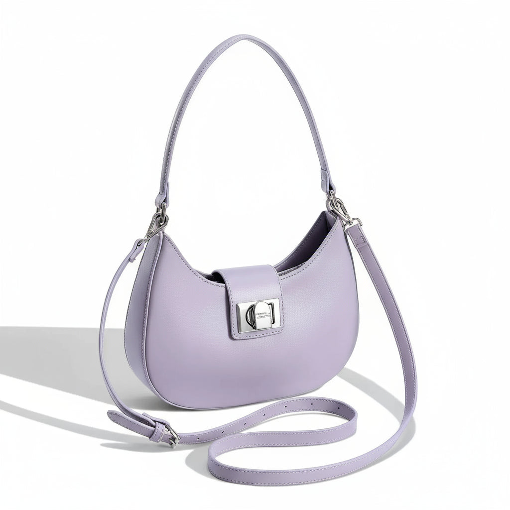 Women's shoulder bag in soft purple faux leather with metal clasp and tassel decoration.