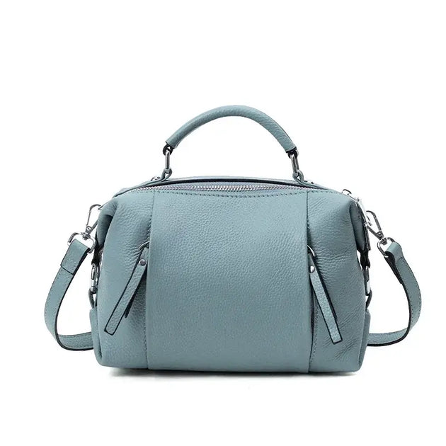 Classic blue leather shoulder bag with ruched detailing and dual carry options for stylish everyday use.