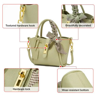 Light green leather women’s handbag with gold lock, scarf handle, and structured design.