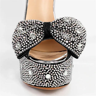 High-quality black platform heels with rhinestone decoration and bow detail, perfect for stylish women.