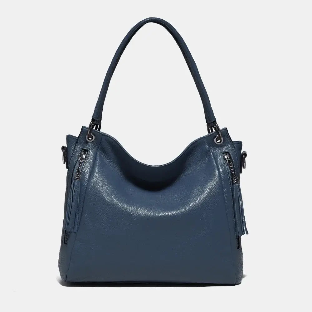 Shoulder hobo bag in blue, made of soft genuine leather with tassel detail and spacious design for women.