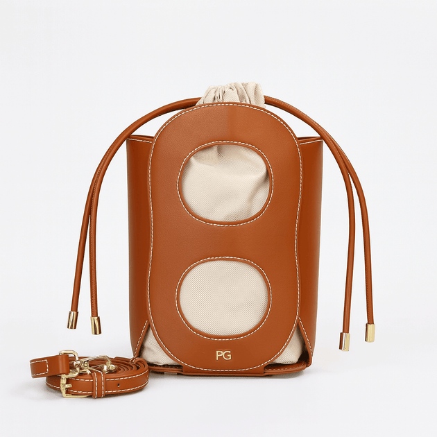 Hollow-out bucket bag in brown, elegant summer accessory with drawstring closure and canvas lining, Model P3117.