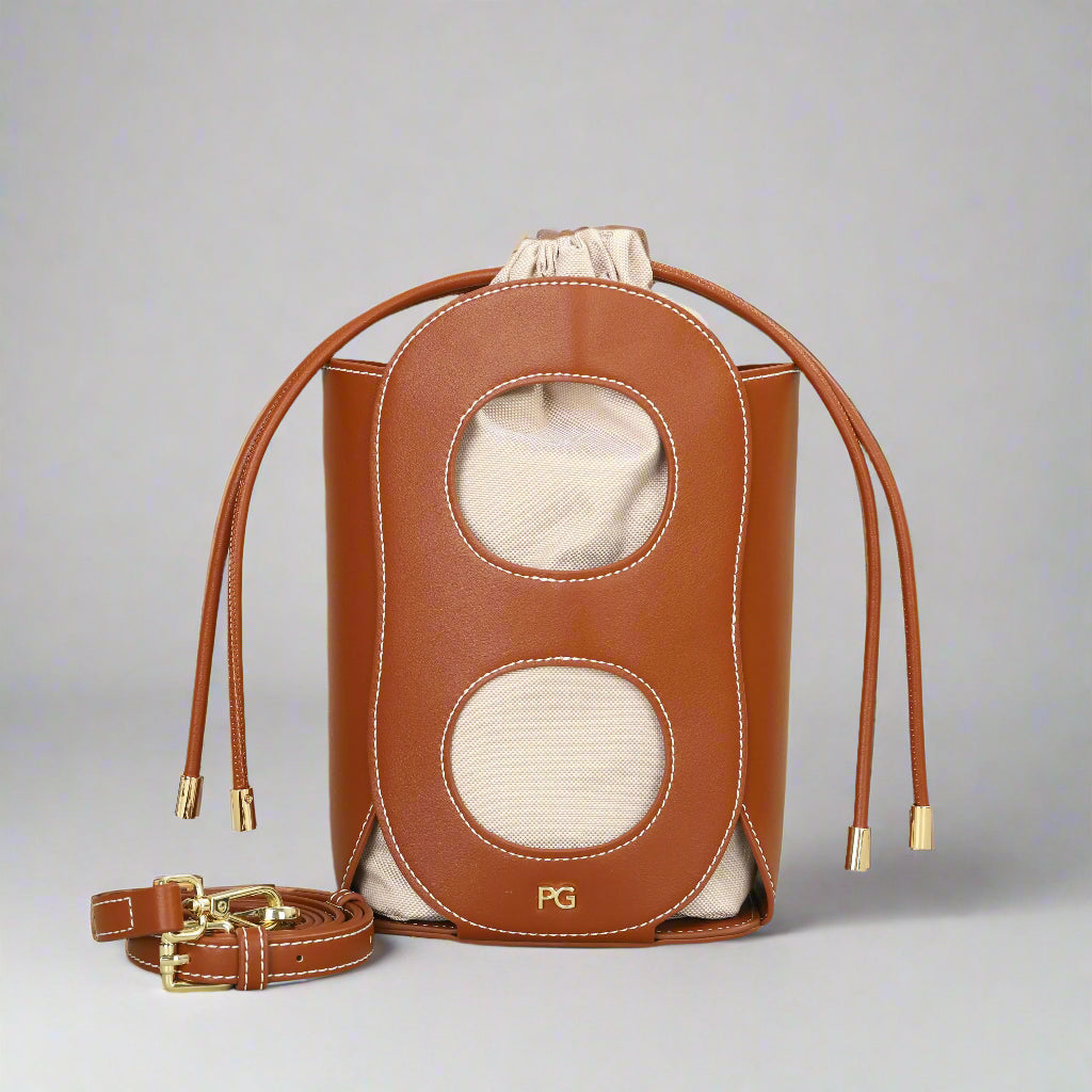 Fashionable brown women's hollow-out bucket bag with drawstring closure, perfect for summer occasions.