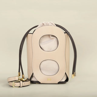 Stylish beige women's hollow-out bucket bag with geometric design, perfect for summer outings and casual wear.