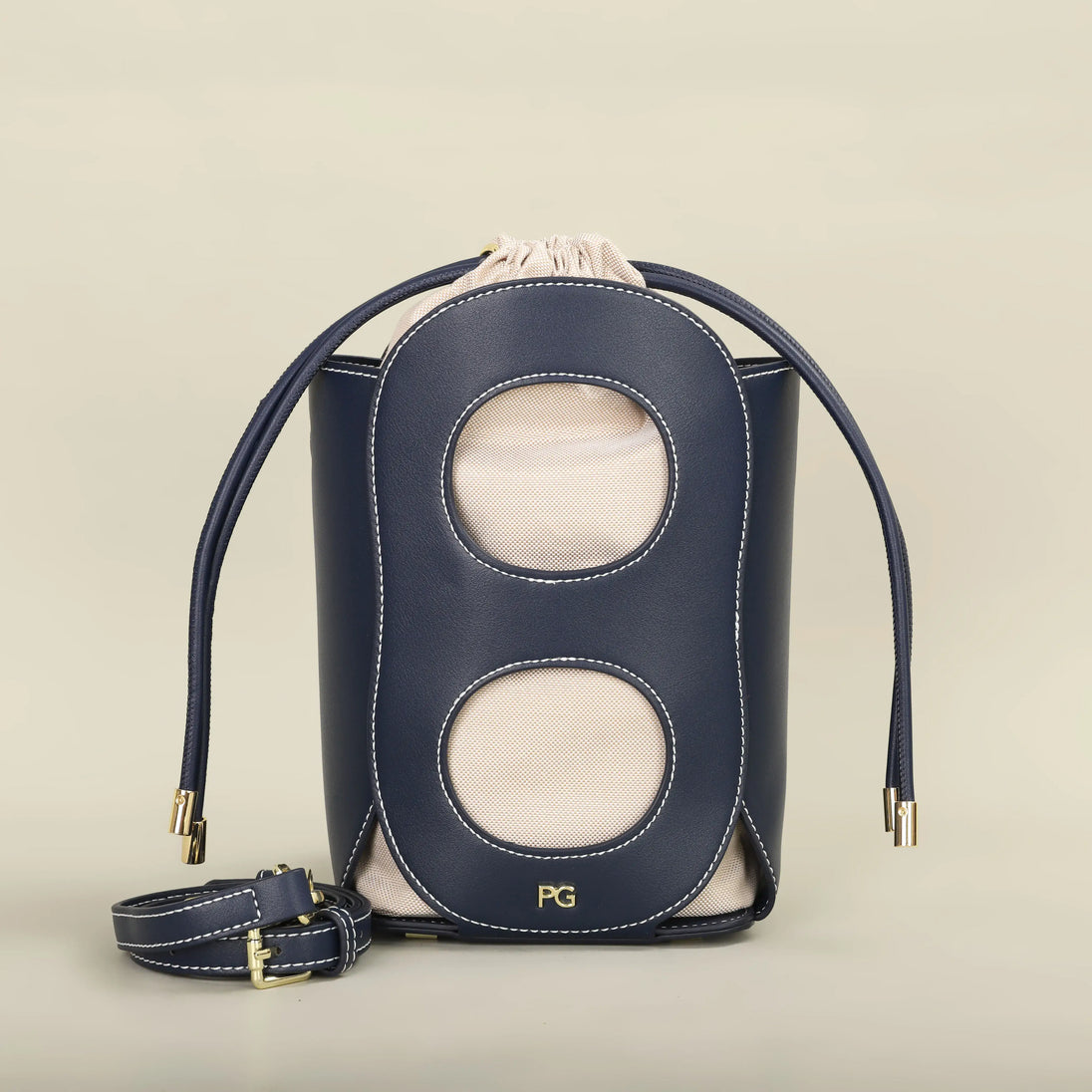 Fashionable navy hollow-out bucket bag with canvas lining, ideal for summer outings and casual occasions.