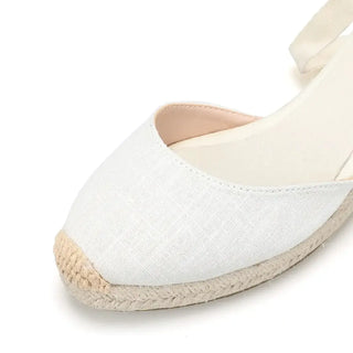 White espadrille sandals with cross-strap design, perfect for casual daily wear.