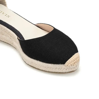 Black espadrille sandals with cross-strap design and woven jute sole, perfect for casual daily wear.