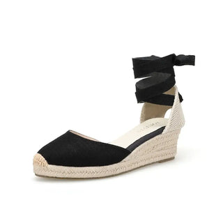 Black espadrille sandals with cross-strap design, perfect for comfortable daily wear.