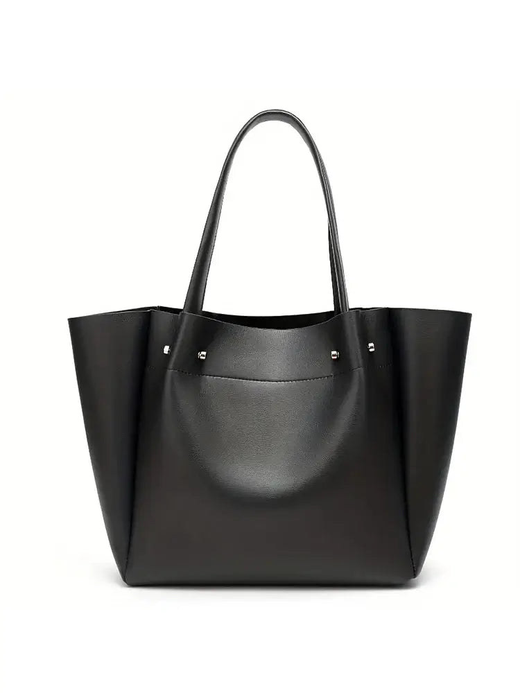 Women's large black tote bag in faux leather with minimalist design for casual occasions.