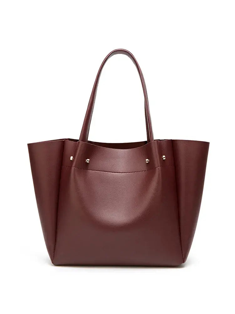 Burgundy casual tote bag in faux leather with minimalist design for women, perfect for versatile occasions.