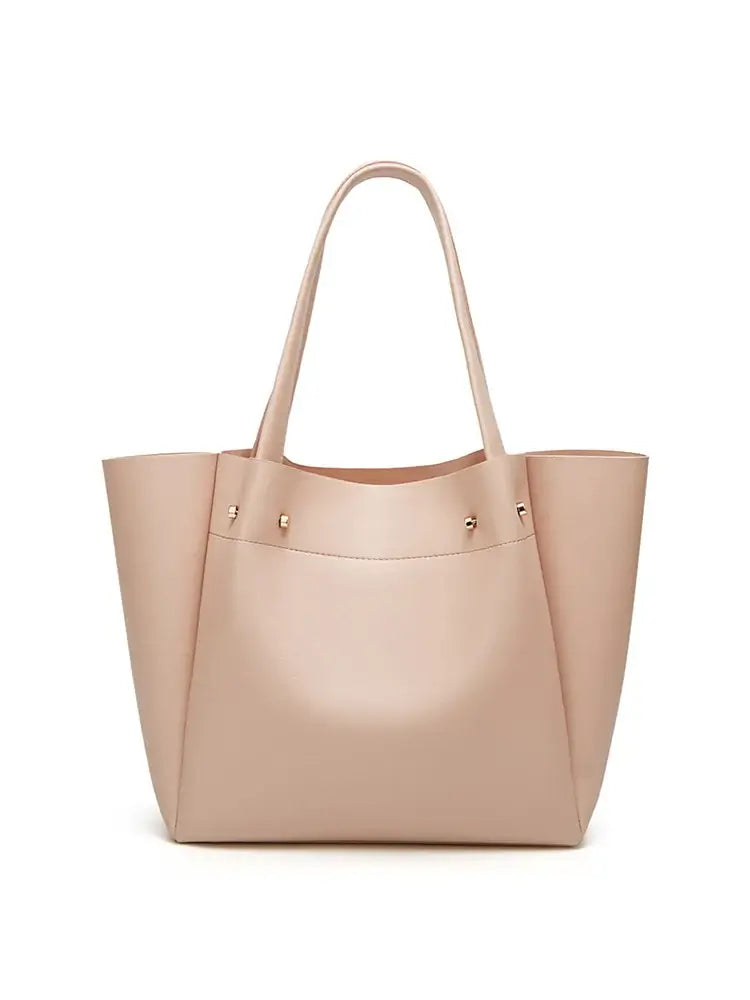 Women's large beige tote bag in faux leather, minimalist design, perfect for casual occasions.