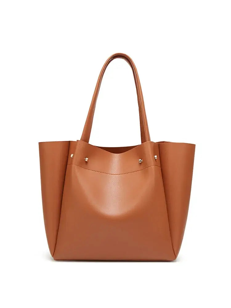 Casual tote bag in caramel brown faux leather with minimalist design for women, perfect for versatile occasions.