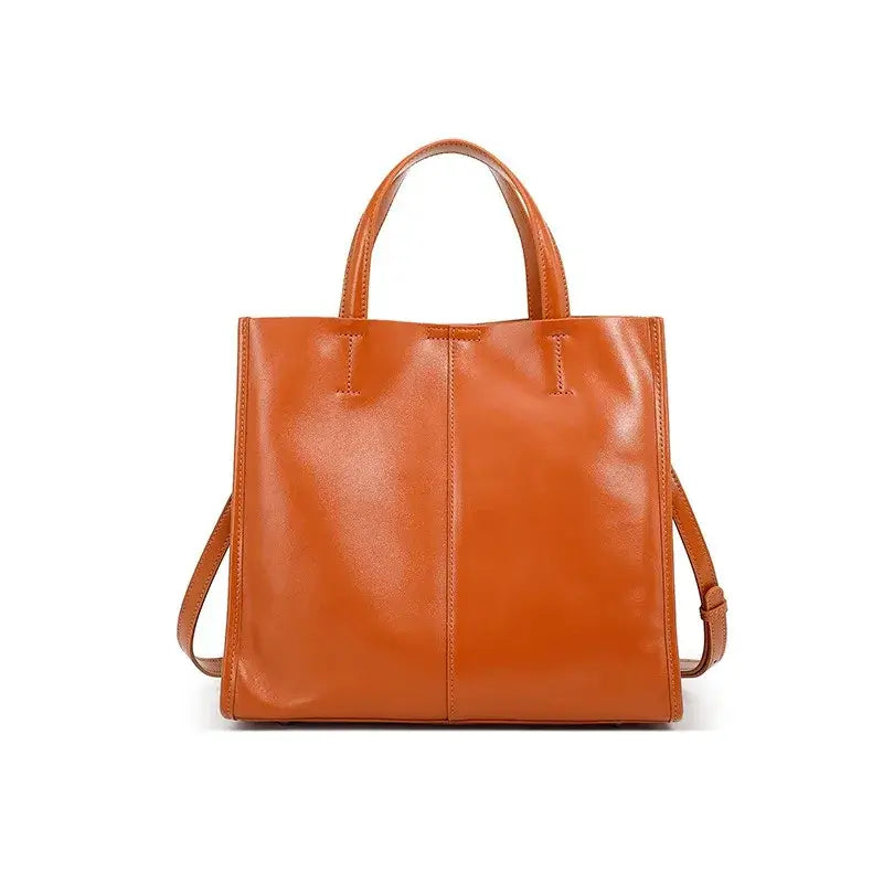 Leather Handbag in rich tan color, structured and elegant design, perfect for shoulder or crossbody wear.
