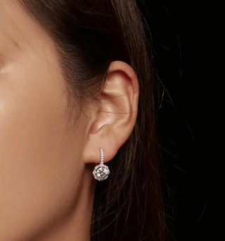Women’s Moissanite Hoop Earrings in 925 Sterling Silver showcasing brilliant sparkle on the model's ear.