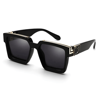 Women's oversized black square sunglasses with gold detail, trendy eyewear for outdoor use.