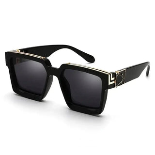 Women's oversized black square sunglasses with gold detail, trendy UV400 eyewear for outdoor use.